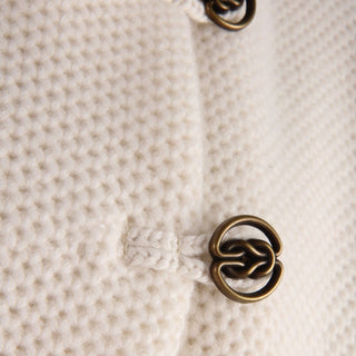 Close-up of a textured fabric with a decorative metal button