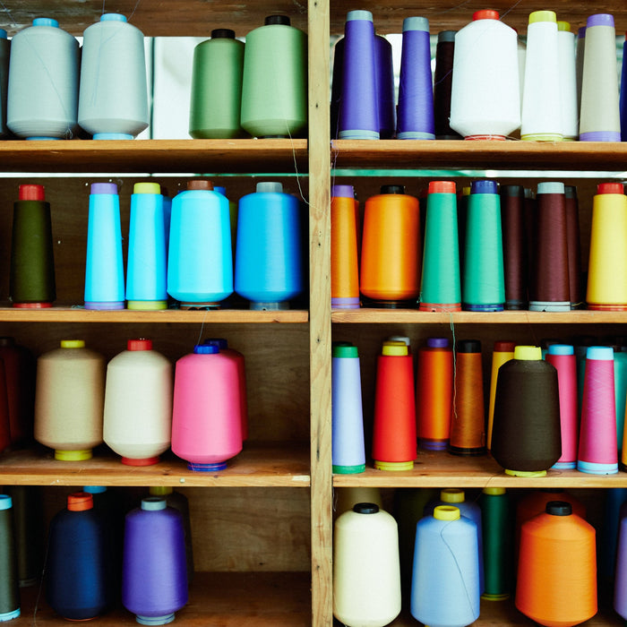 Lots of colourful yarn on a shelf