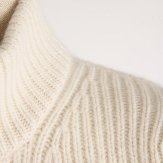Close-up of beige knitted fabric on a light background