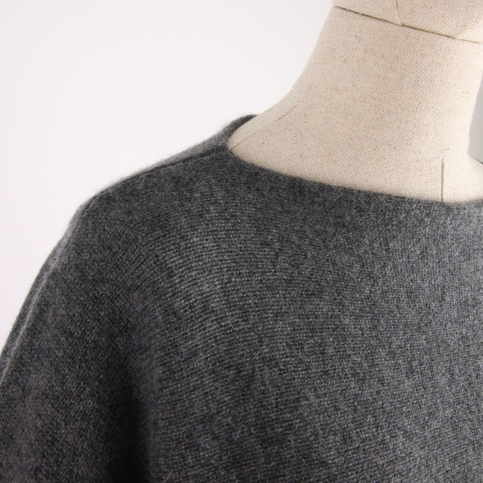 Gray sweater on a mannequin with a plain background