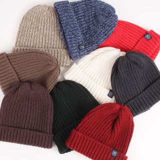 Collection of knit beanie hats in various colors on a white background