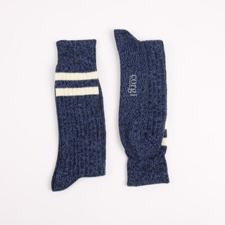 Pair of blue socks with white stripes on a white background