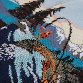 Close-up of a knitted fishing scene design with intricate patterns and colours.
