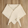 cream triangle scarf folded on a wooden surface