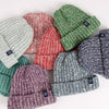 Collection of colorful knit hats on a white background