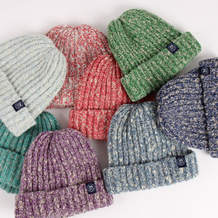 Collection of colorful knit hats on a white background