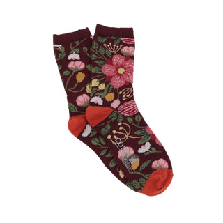 Floral patterned socks with burnt orange accents on a white background