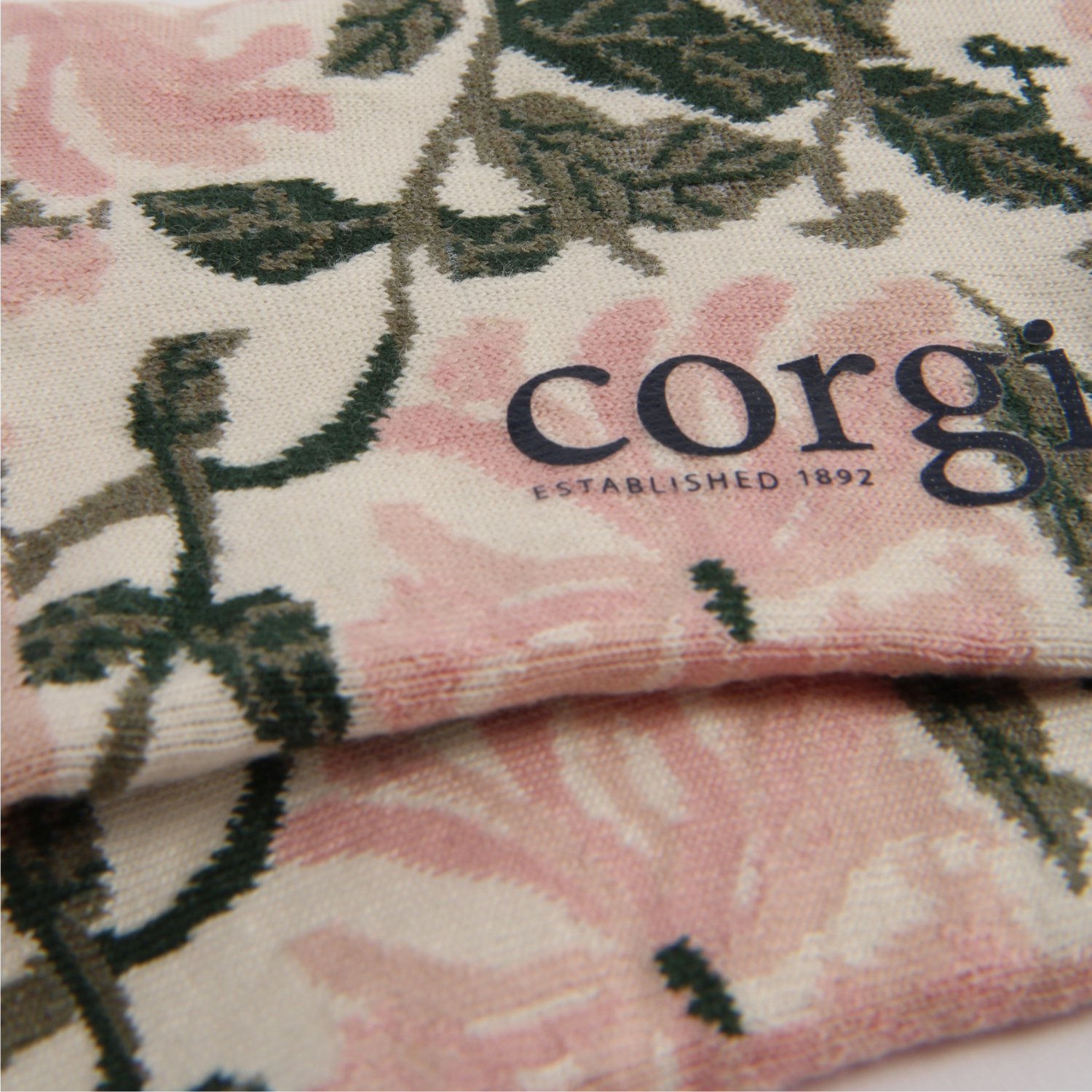 Floral patterned fabric with 'corgi' branding on a white background