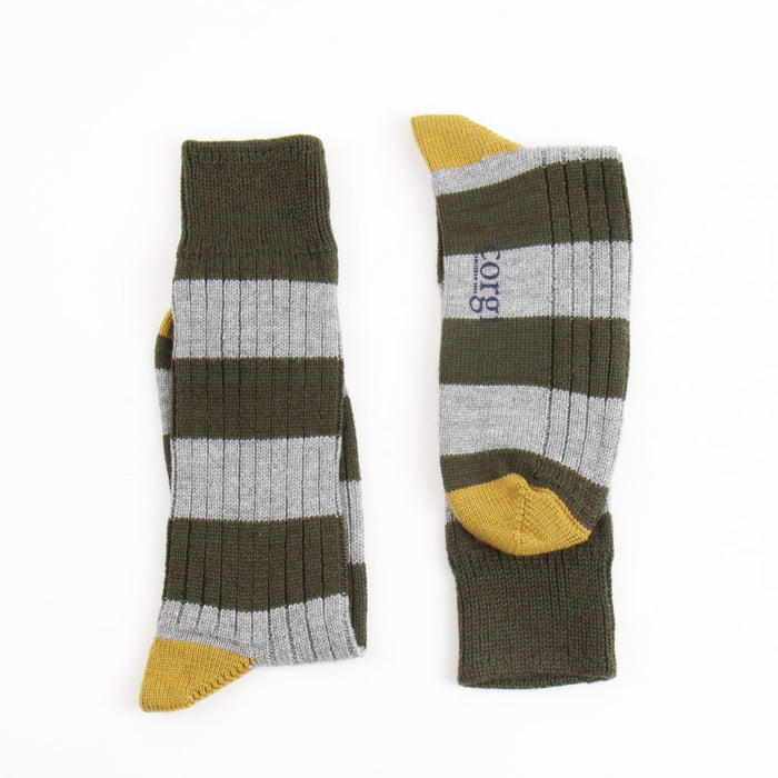 Pair of striped socks with yellow accents on a white background