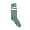 Green sock with white stripes photographed on a white background