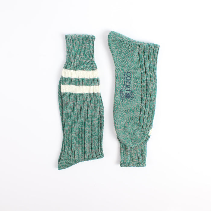 Pair of green socks with a white stripe photographed on a white background
