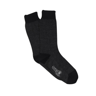A pair of men's formal herringbone merino wool socks in black.