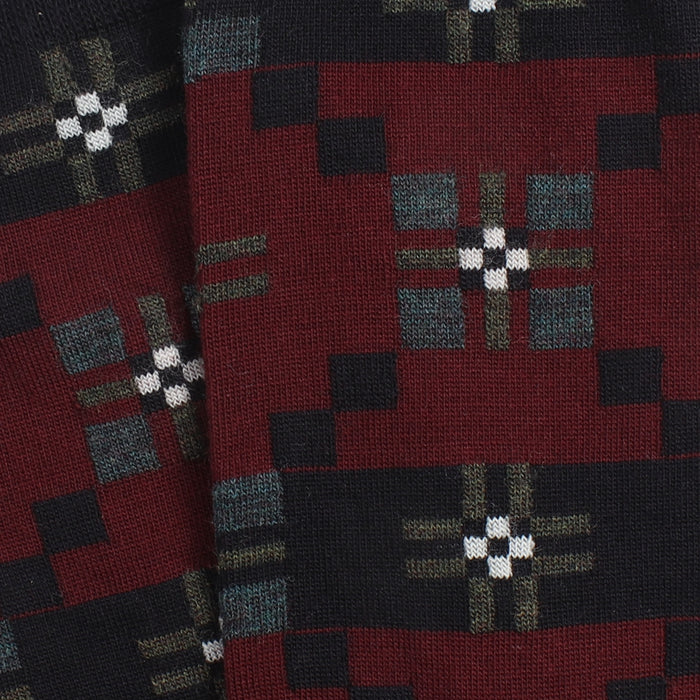 Close-up of a patterned fabric with geometric design on a red background