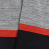Close-up of the sock fabric with silver, orange and wine stripes.