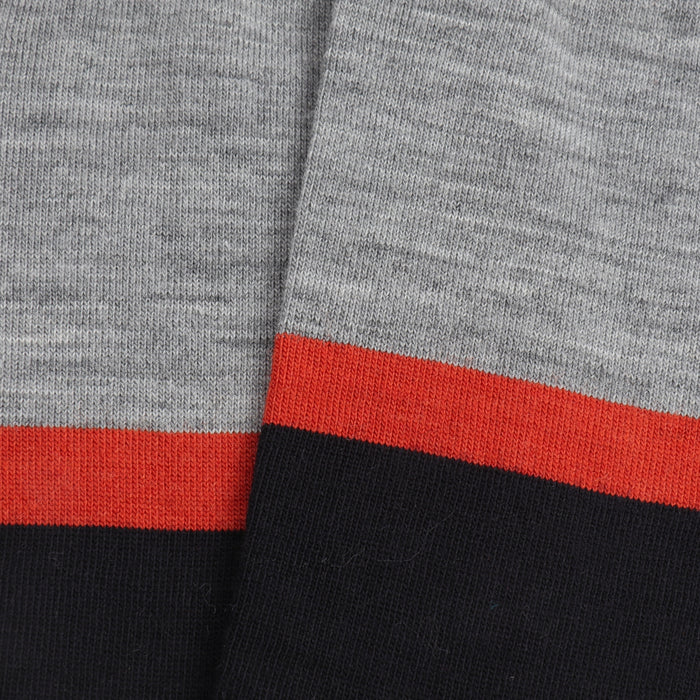 Close-up of the sock fabric with silver, orange and wine stripes.