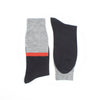 Two socks, side by side, one showing a striped leg the other a solid navy foot photographed on a white background.