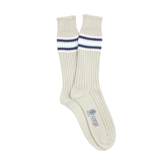 Pair of natural socks with blue and white stripes just below the cuff on a white background