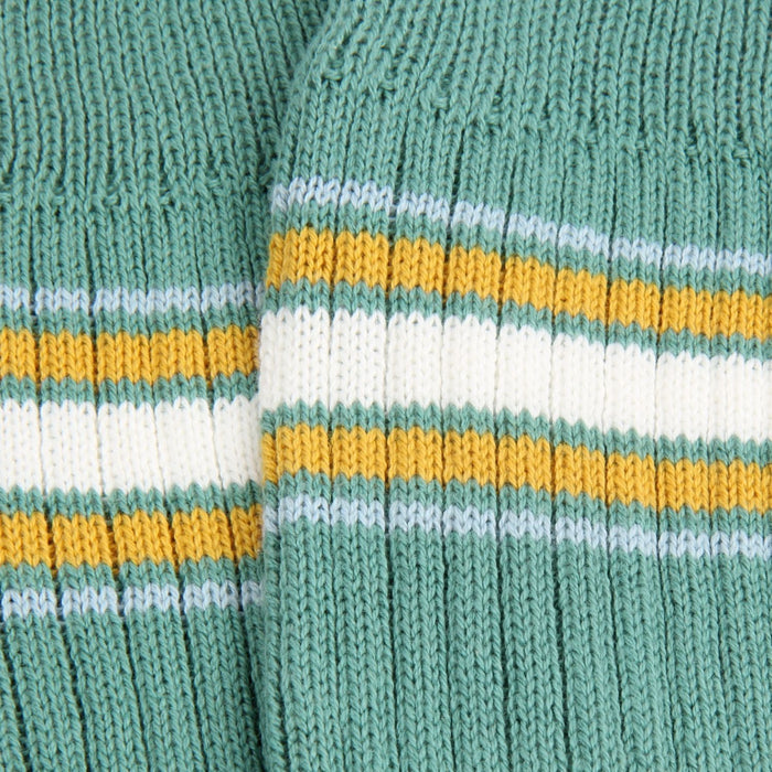 Close-up of a green knitted fabric with multicolored stripes.