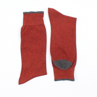 Red socks with gray toes and cuffs on a white background