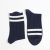 Navy blue socks with two white stripes on  the top end of the sock photographed on a white background