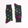 Pair of polka dot socks with purple accents on a white background