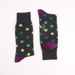 Pair of polka dot socks with purple accents on a white background