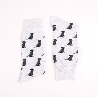 Two grey socks with black labrador retriever pattern on a white background
