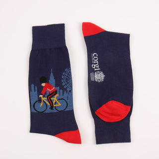 Two socks with a cyclist design in main navy and red accents photographed on a white background
