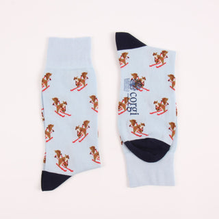 Two pale blue socks with squirrel designs with a navy heel and toe