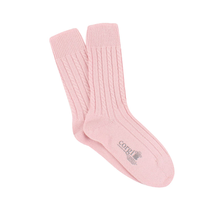 A pair of pink pure cashmere socks with a small scale cable knit pattern.