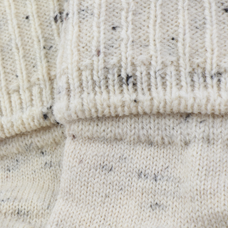 Close-up of textured beige fabric with a ribbed pattern
