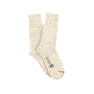 Pair of cream socks with small speckles on a white background