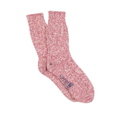 A pair of plain red and white cotton socks worn