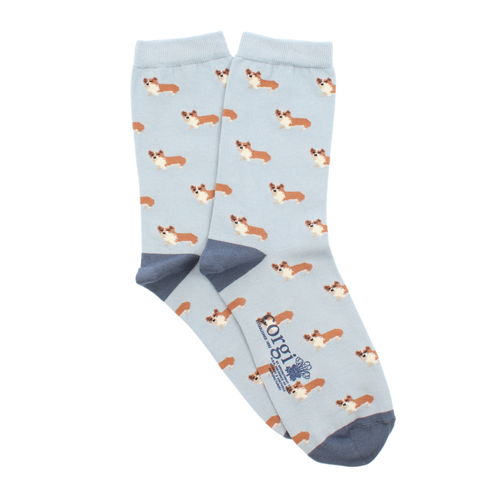 A pair of women's ankle socks with a corgi dog pattern in shades of blue, perfect to be worn with blue jeans.