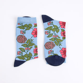 Floral-patterned socks with blue and navy accents on a white background