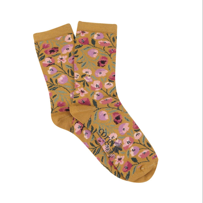 Mustard yellow socks with floral pattern on a white background