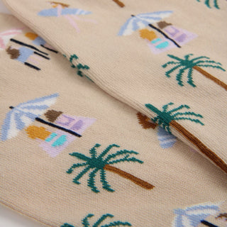 Close-up of fabric with beach-themed mini icons including palm trees and umbrellas.