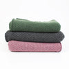 stacked ponchos on a white background