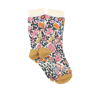 A pair of patterned cotton socks featuring a floral design with roses and leaves, and gold accents on the heel and toe, displayed against a yellow background.