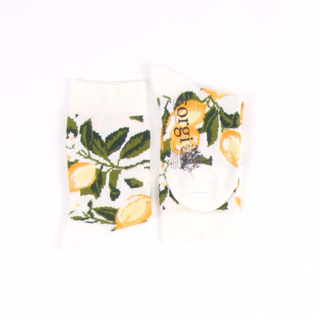 Two socks with lemon and leaf pattern on a white background