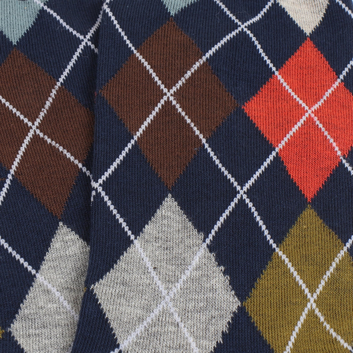 Close-up of argyle pattern with navy, brown, red, gray, and gold colors.