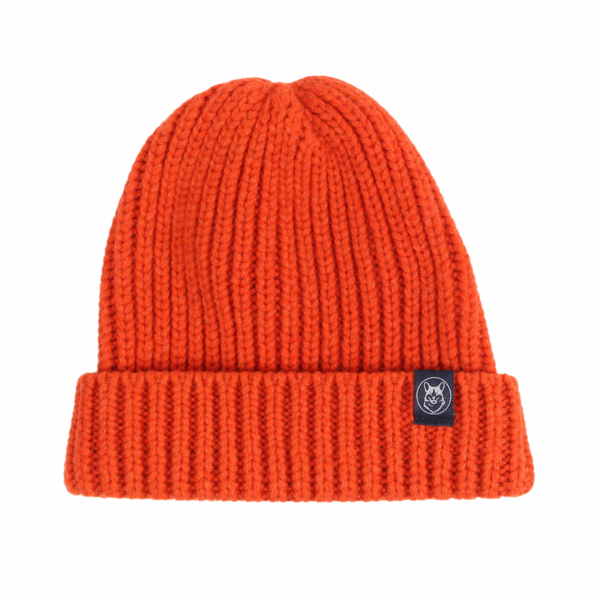 Bright orange ribbed knit beanie hat with a folded cuff and a small black brand patch on the side, shown against a plain white background.
