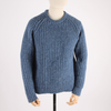 Blue knitted sweater on a mannequin against a white background