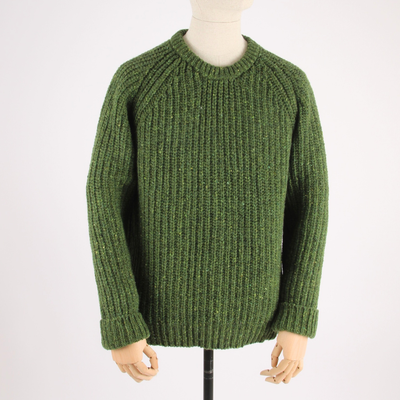 Green knitted sweater on a mannequin against a white background