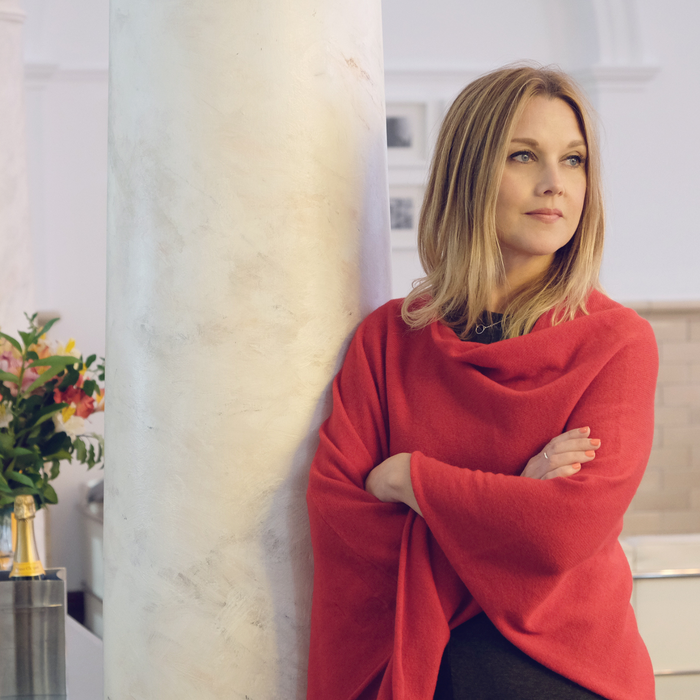 Woman wearing a red poncho in a grand setting
