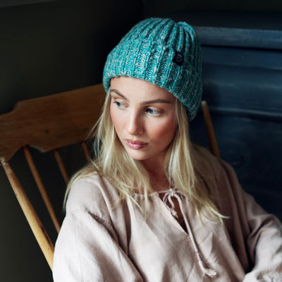 person wearing a green cashmere blend beanie