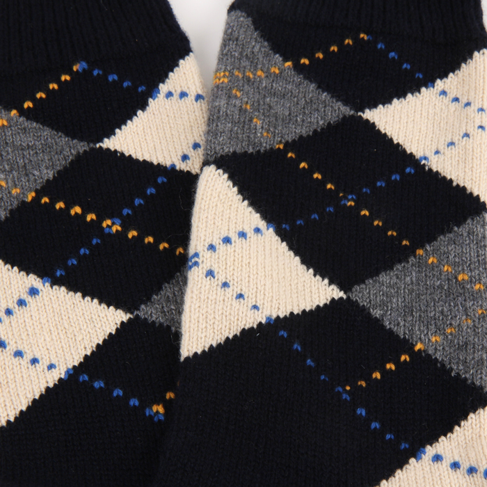 Close-up of a patterned fabric with navy, grey, and cream colours.