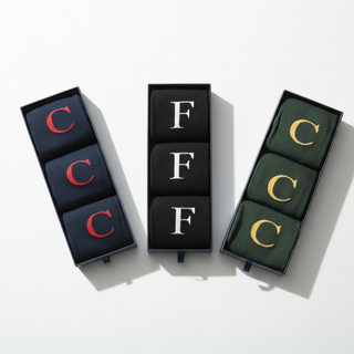 Men's Letter Socks in gift boxes on a festive table.