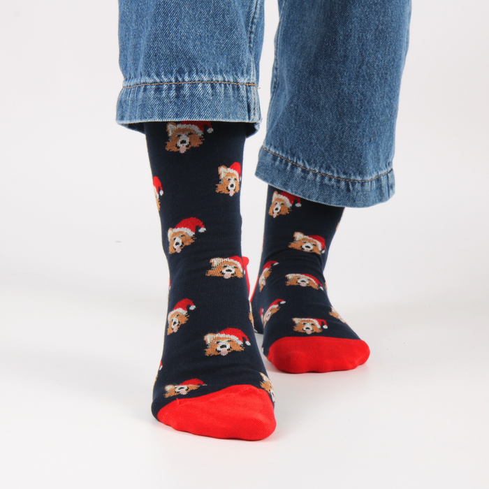 Navy blue socks with a corgi dog pattern worn with jeans