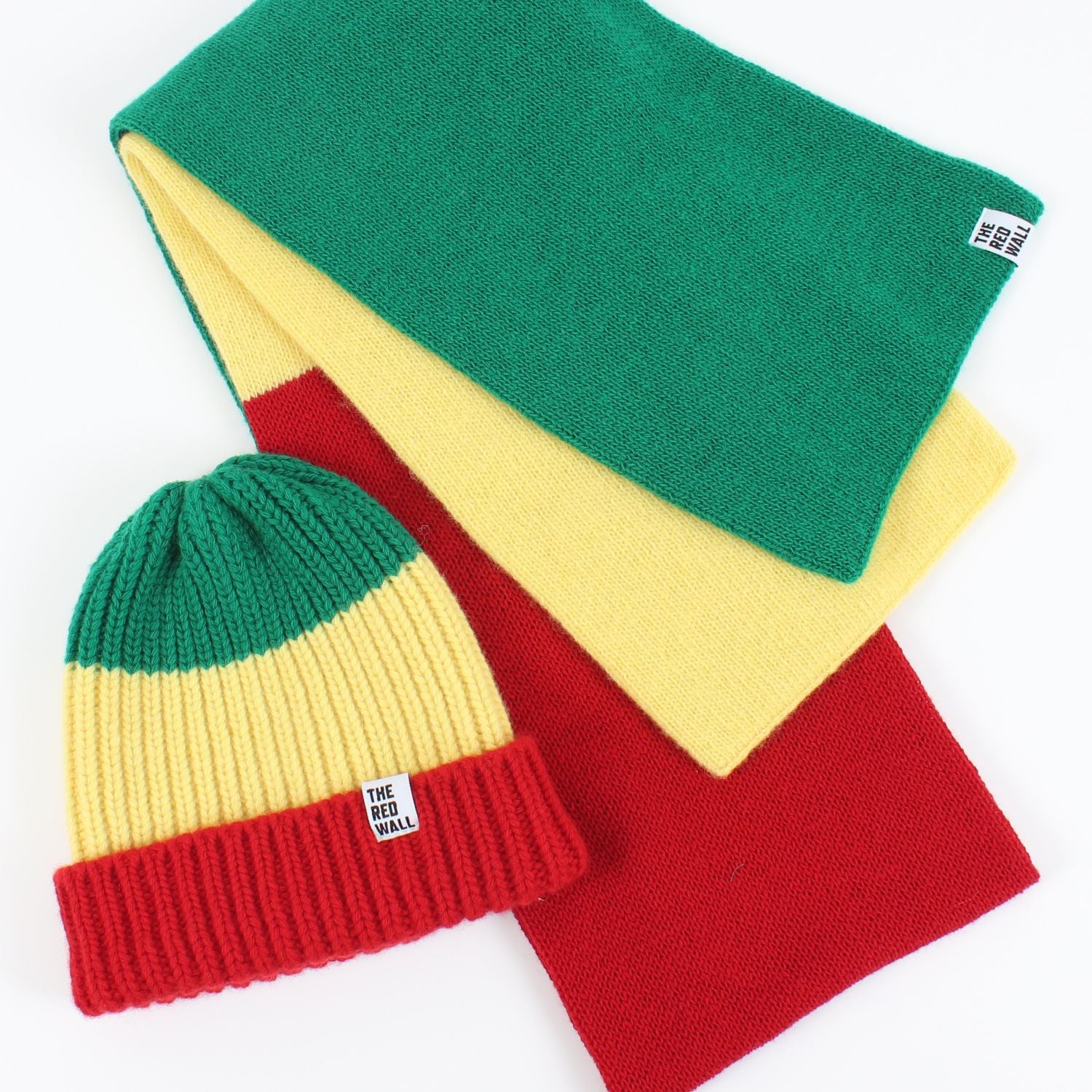 Hat and scarf laid flat on a white background.